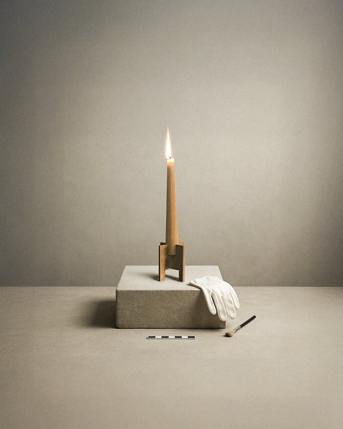 A calm archeological scenery of a brass Lyssier candle holder holding a burning beeswax candle while standing on a podest from natural stone. Besides lays a glove and a brush, as well as a ruler which lays in front.
