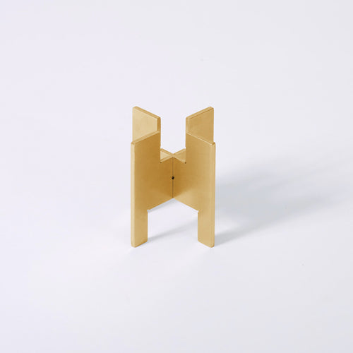 Minimalist portable Lyssier H64 candleholder in solid brass, made from two interlocking pieces. Shown assembled with the taper candle side facing up.